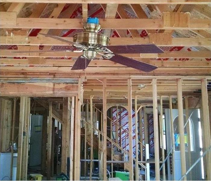Fan Hanging from ceiling and house frame 