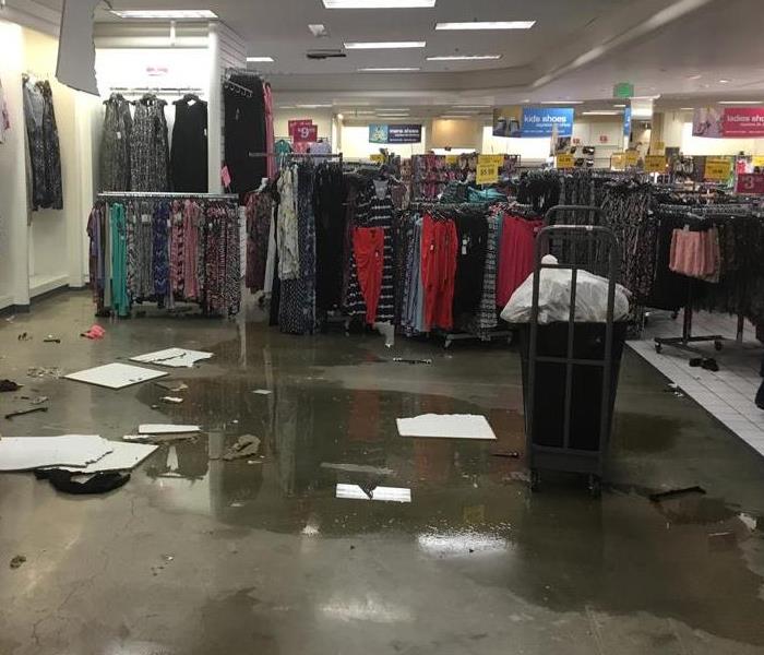 HUGE PUDDLE OF WATER IN MIDDLE OF COMMERCIAL BUSINESS 