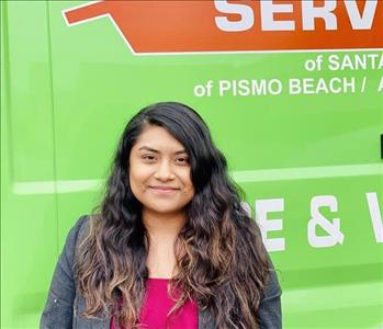 Female smiling background green SERVPRO van