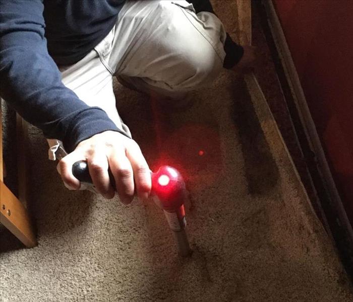 man holding device kneeling down 